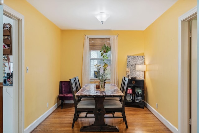 dining space with light hardwood / wood-style floors