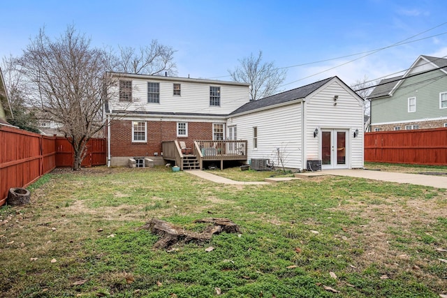 back of house with a yard, cooling unit, a deck, and french doors