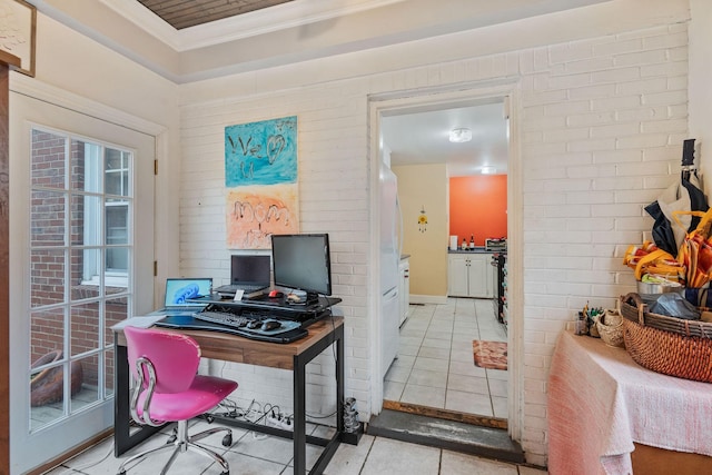 office space with ornamental molding, light tile patterned flooring, and brick wall