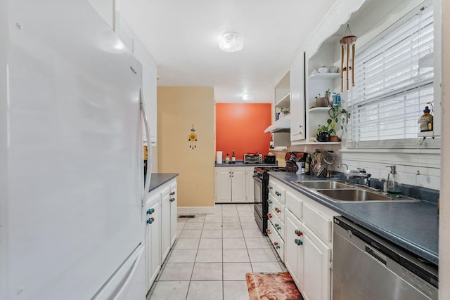 kitchen featuring sink, gas stove, white cabinetry, stainless steel dishwasher, and white fridge