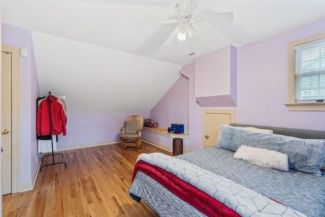 bedroom featuring lofted ceiling, ceiling fan, and light hardwood / wood-style flooring