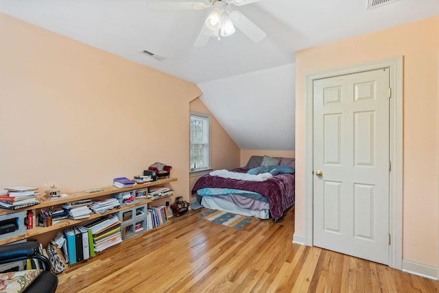 bedroom featuring ceiling fan, lofted ceiling, and light wood-type flooring