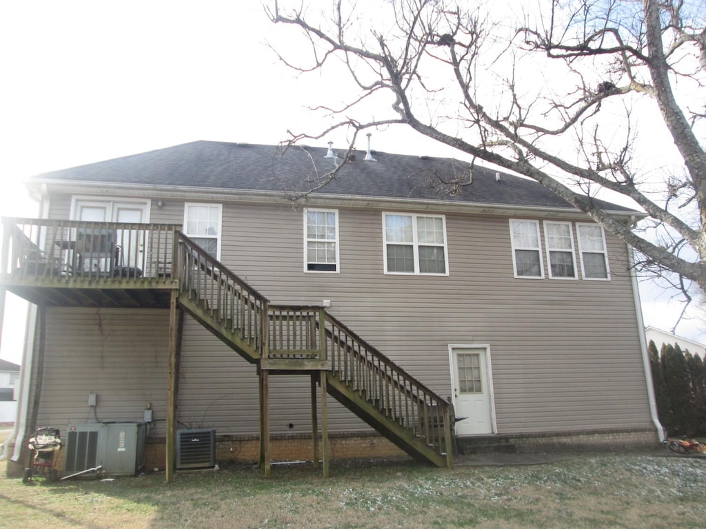 rear view of house featuring a deck and cooling unit