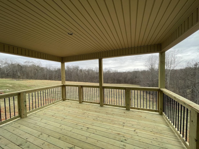 wooden deck featuring a view of trees