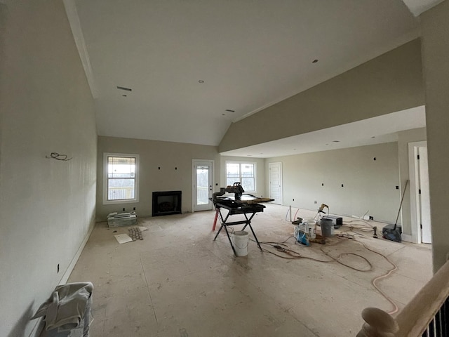 living area featuring high vaulted ceiling and a fireplace