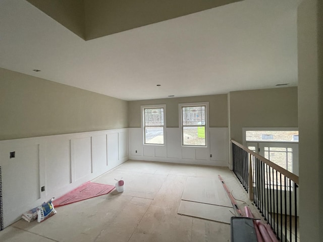 empty room with a wainscoted wall and a decorative wall