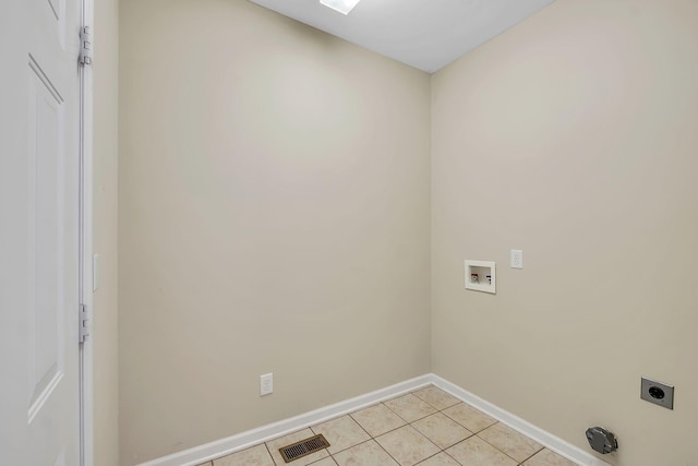 clothes washing area featuring light tile patterned floors, hookup for a washing machine, and hookup for an electric dryer