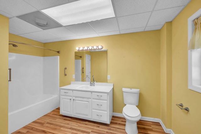 full bathroom with toilet, vanity, wood-type flooring, and tub / shower combination