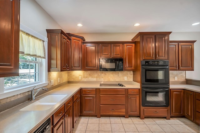 kitchen with black appliances, light tile patterned floors, decorative backsplash, and sink