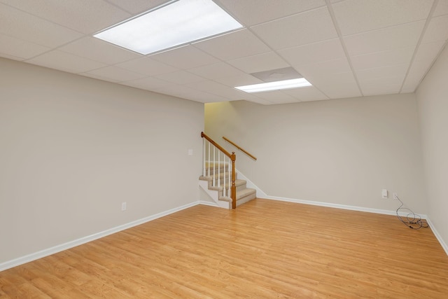 unfurnished room featuring wood-type flooring and a paneled ceiling