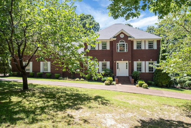 colonial-style house with a front yard