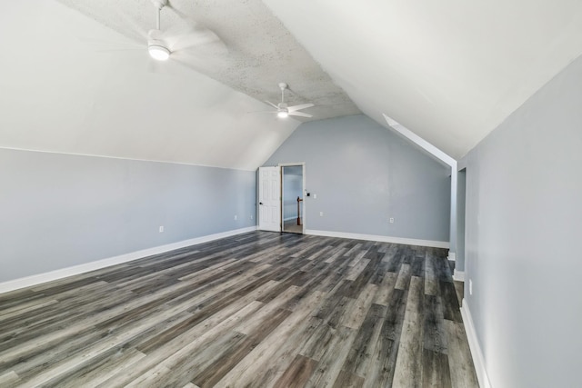 additional living space featuring vaulted ceiling, ceiling fan, a textured ceiling, and dark hardwood / wood-style floors