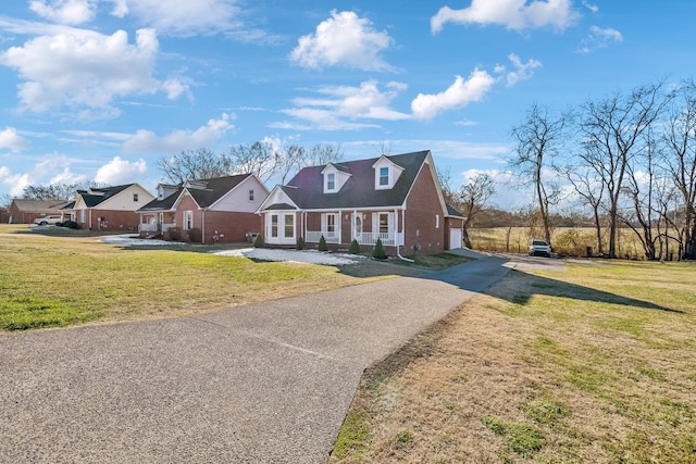 cape cod-style house with a front lawn