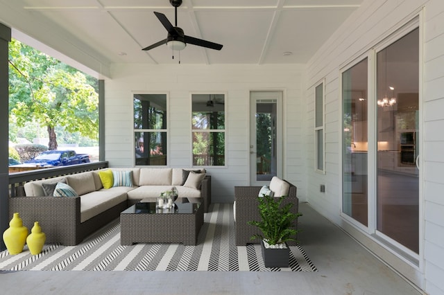 sunroom / solarium featuring ceiling fan