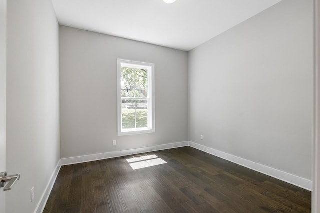 spare room featuring dark wood-type flooring