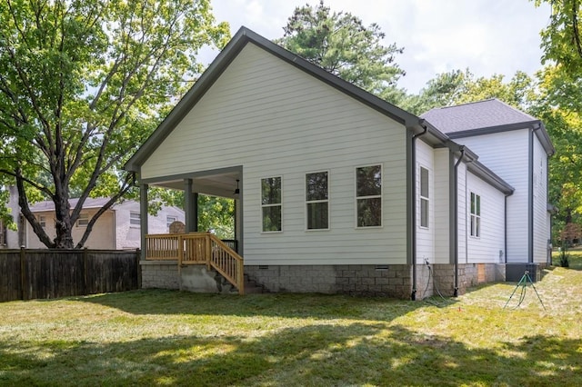 rear view of house with a yard