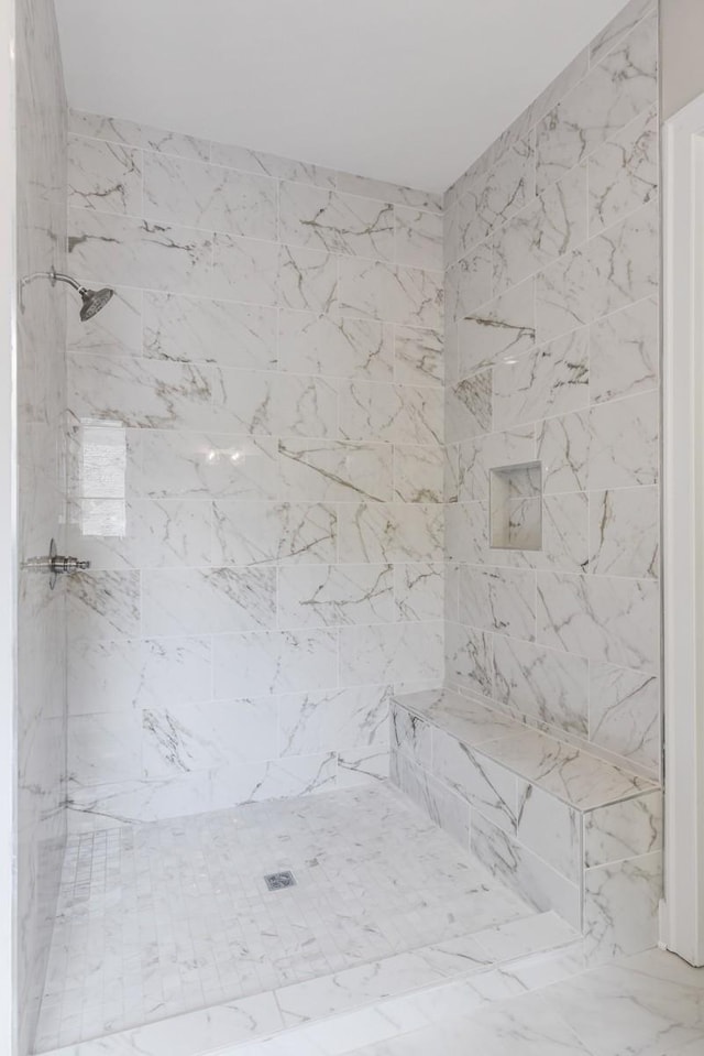 bathroom with a tile shower