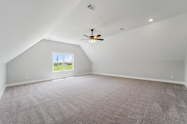 additional living space featuring ceiling fan, lofted ceiling, and carpet flooring