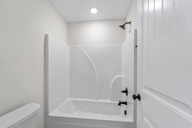 bathroom with toilet and shower / bathing tub combination