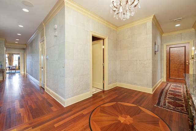 corridor with dark wood-type flooring, crown molding, and a notable chandelier