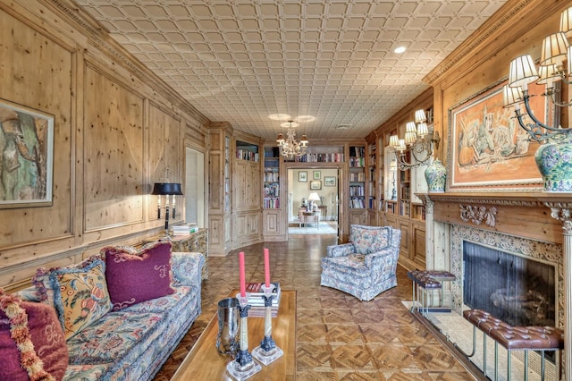 living room with parquet flooring, a tile fireplace, and ornamental molding