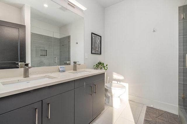 bathroom featuring tile patterned floors, toilet, a shower with shower door, and vanity