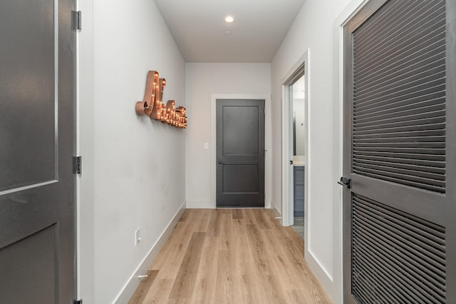 hallway with light hardwood / wood-style flooring