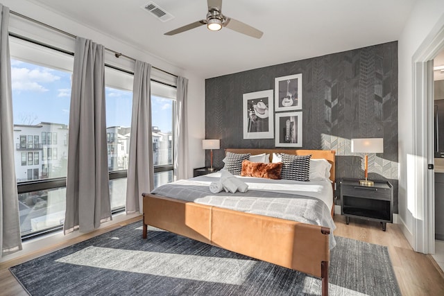 bedroom with hardwood / wood-style flooring and ceiling fan