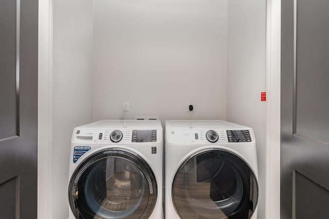 washroom with independent washer and dryer