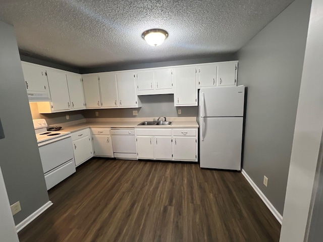 kitchen with dark hardwood / wood-style floors, sink, white cabinets, and white appliances