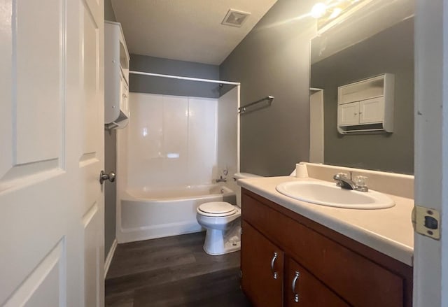 full bathroom with wood-type flooring, washtub / shower combination, vanity, and toilet