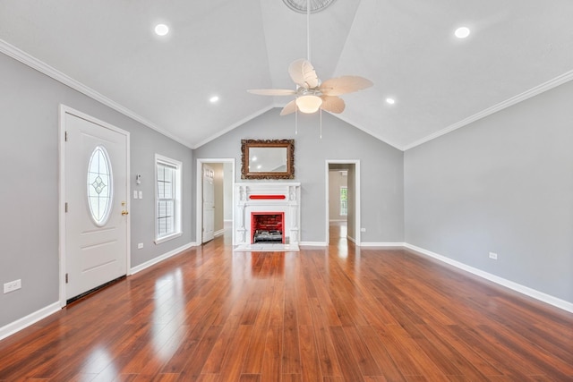 unfurnished living room with ceiling fan, dark hardwood / wood-style floors, ornamental molding, and lofted ceiling