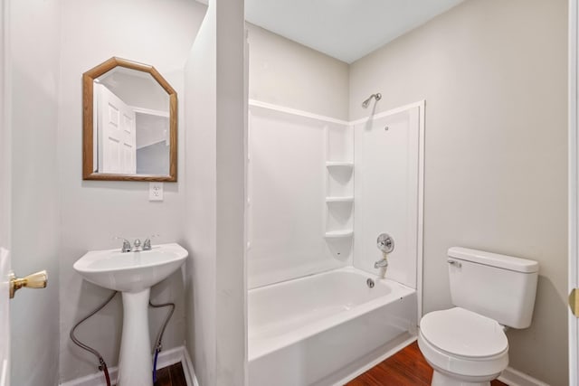 full bathroom with hardwood / wood-style flooring, sink, toilet, and  shower combination