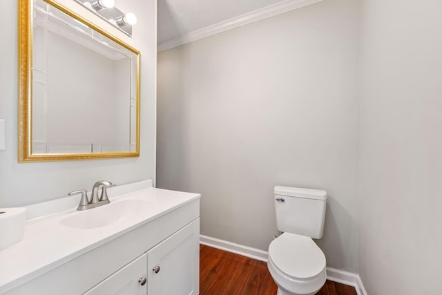 bathroom with hardwood / wood-style floors, toilet, vanity, and crown molding