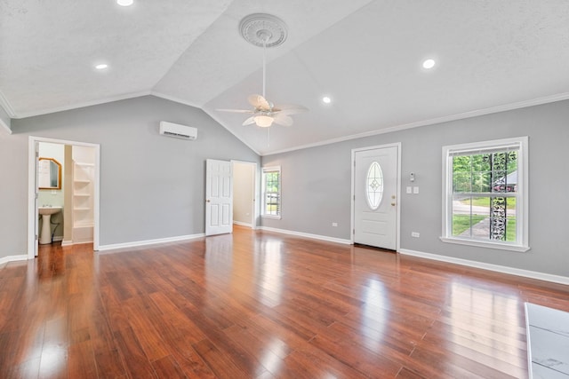 unfurnished living room featuring lofted ceiling, ceiling fan, a wall mounted AC, a textured ceiling, and dark hardwood / wood-style flooring