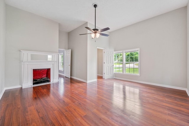 unfurnished living room featuring dark wood-type flooring, ceiling fan, and high vaulted ceiling