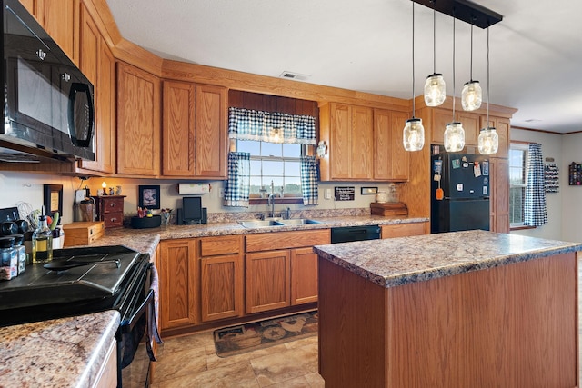 kitchen with a wealth of natural light, sink, a center island, and black appliances