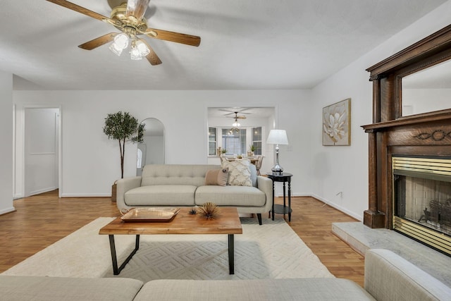 living room featuring light hardwood / wood-style floors and ceiling fan