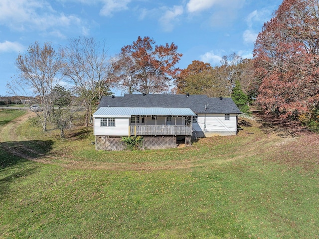 rear view of property with a lawn and covered porch