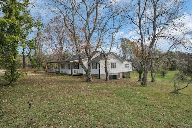 view of home's exterior featuring a lawn, central AC, and covered porch