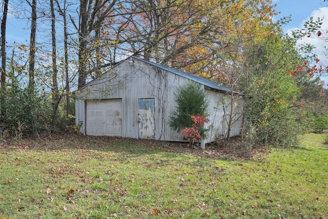 view of outbuilding featuring a yard and a garage