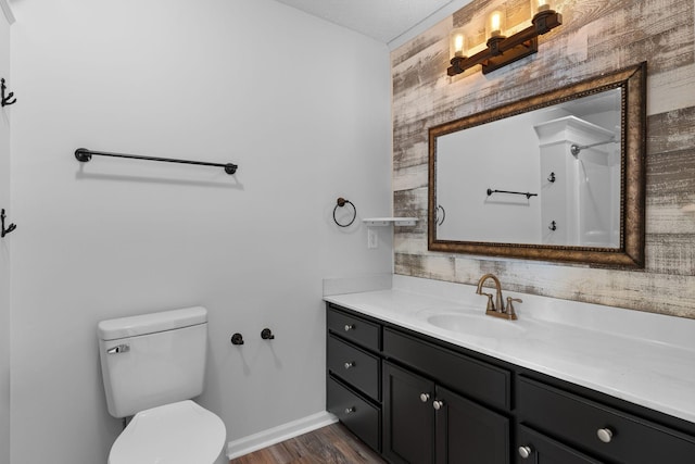 bathroom featuring vanity, a shower, hardwood / wood-style floors, and toilet