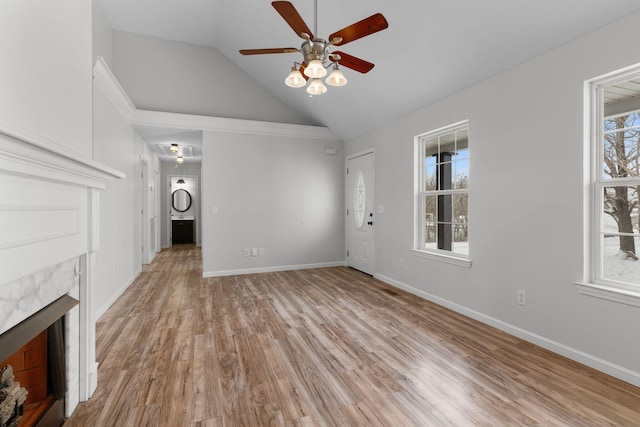 unfurnished living room with ceiling fan, a fireplace, high vaulted ceiling, and light hardwood / wood-style flooring