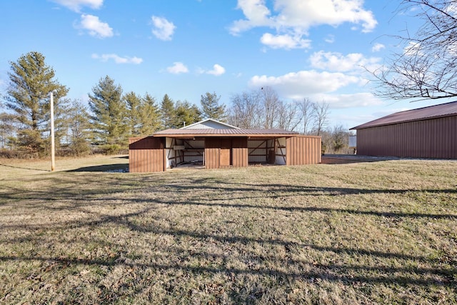 view of outbuilding featuring a lawn