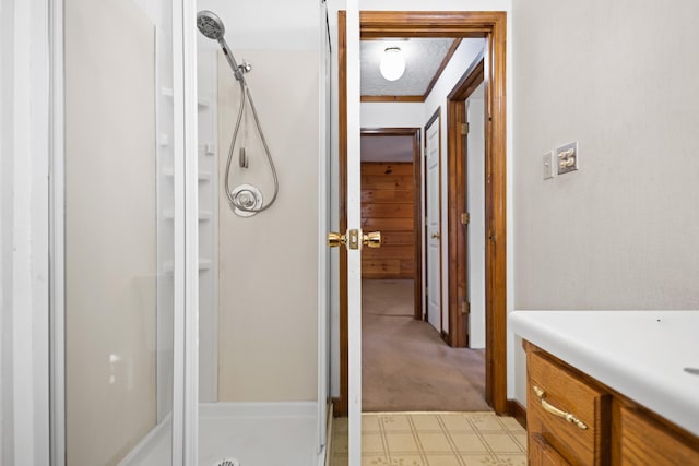 bathroom featuring an enclosed shower and a textured ceiling