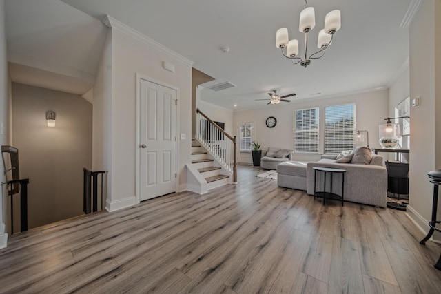 living room with crown molding, light hardwood / wood-style flooring, and ceiling fan with notable chandelier