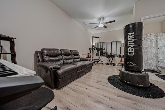 living room featuring ceiling fan, lofted ceiling, and light hardwood / wood-style floors