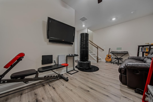 exercise room featuring light wood-type flooring