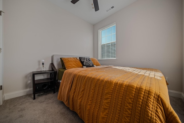 bedroom with ceiling fan, vaulted ceiling, and carpet