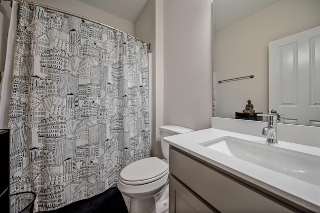 bathroom featuring vanity, toilet, and curtained shower